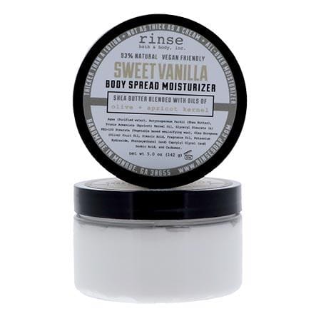 Sweet Vanilla Body Spread jar with lid propped on bright white — thick white cream in a clear jar