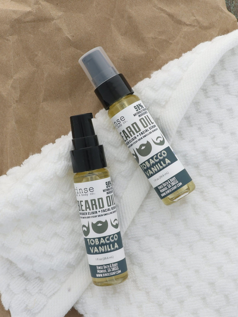 Tobacco Vanilla Beard Oil pair resting on honeycomb towel over kraft paper — warm textured flat lay