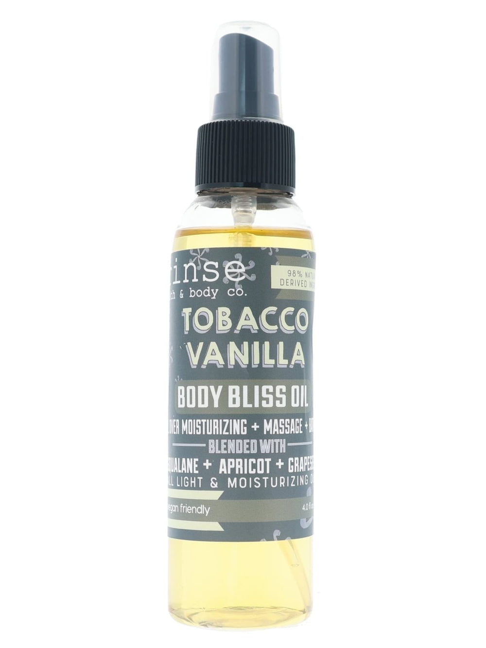 Tobacco Vanilla Body Bliss Oil standing on bright white — pale gold oil and charcoal label in studio light