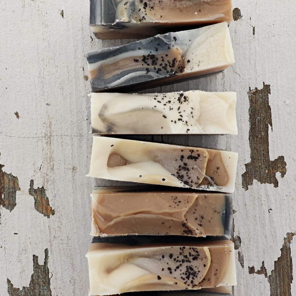 Tobacco Vanilla bar soap styled on a neutral surface — the masculine-leaning warm scent for him or for anyone who likes vanilla with smoke in it. Rinse Bath & Body Co.
