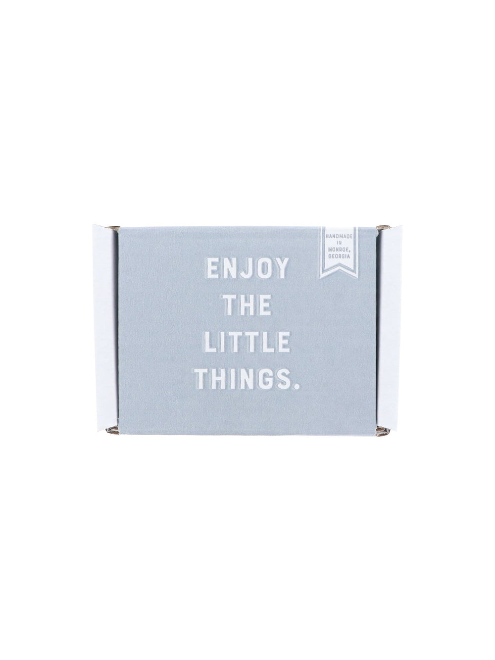 Closed grey Trying Natural box rests on white — ENJOY THE LITTLE THINGS printed on the soft lid.