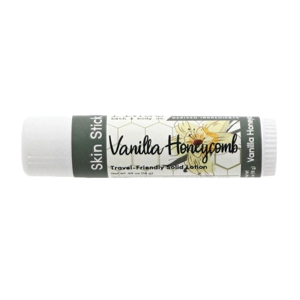 Vanilla Honeycomb Skin Stick lies horizontal — cursive name and honeycomb pattern on sterile white